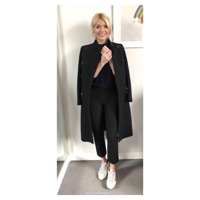 Holly Willoughby This Morning outfit black coat trousers and top white trainers with gold star MArch 2018
