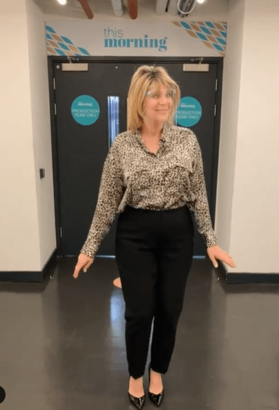 where to get all Ruth Langsford This Morning outfits satin leopard print shirt black trousers black patent court shoes 16 February 2021 Photo Ruth Langsford