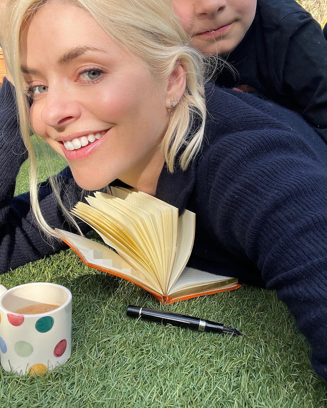 Holly Willoughby lying on the grass 18 April 2021