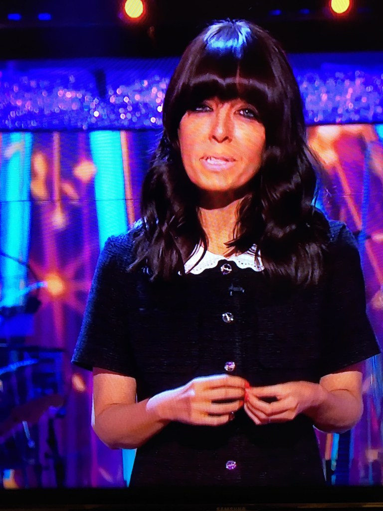 where to get all Claudia Winkleman Strictly dresses black tweed short dress button front white collar white court shoes 17 October 2021 Photo BBC
