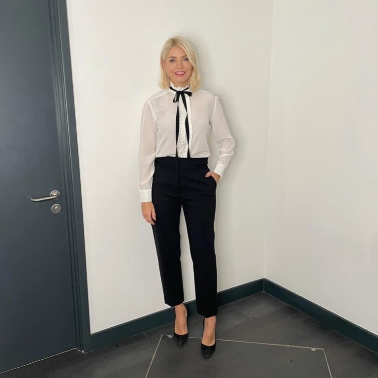 where to get all Holly Willoughby This Morning outfits white ecru blouse with black ribbon black trousers black suede court shoes 7 October 2021 Photo Holly Willoughby