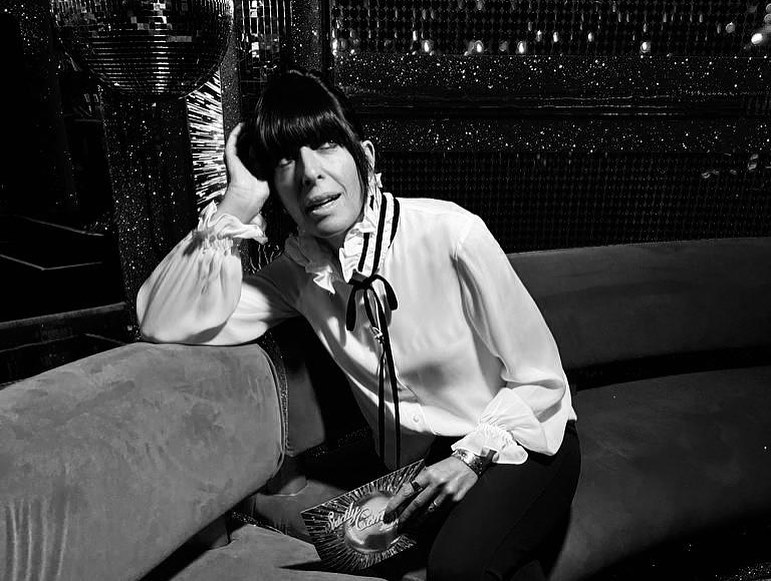 where to get all Claudia Winkleman Strictly Come Dancing outfits white ruffle blouse blsck velvet ties black trousers 12 December 2022 Photo Claudia Winkleman