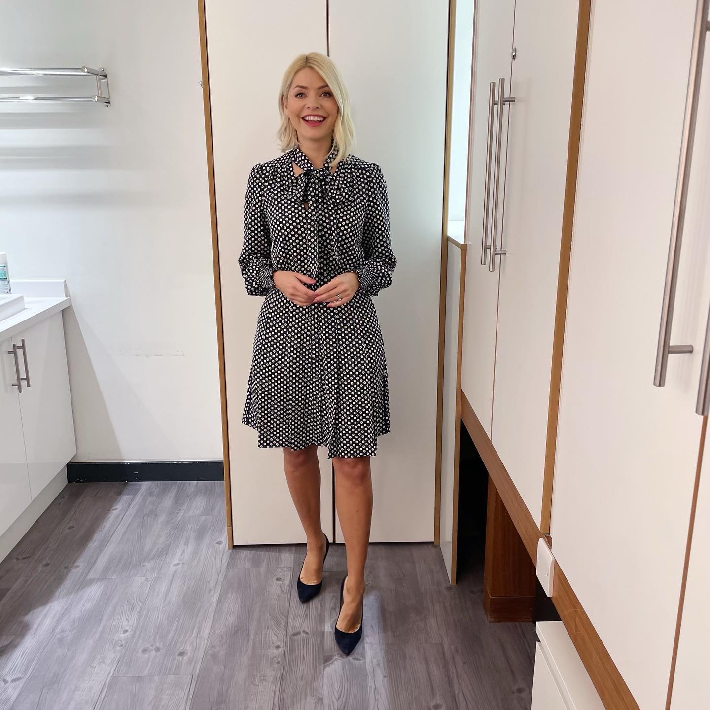 where to get all Holly Willoughby This Morning outfits dresses navy and cream polka flower print tie neck dress blue suede court shoes 31 January 2023 Photo Holly Willoughby