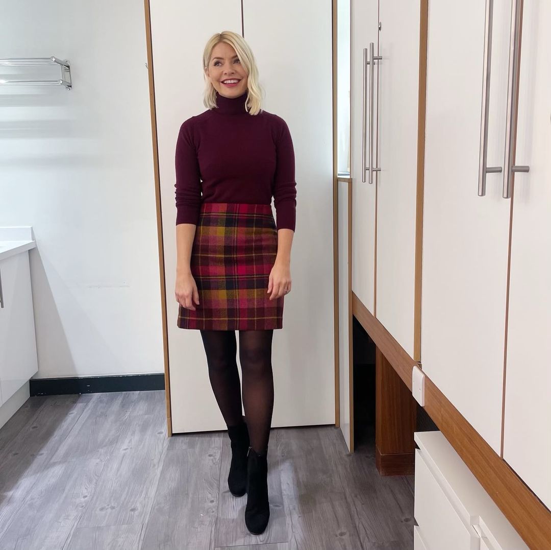 where to get all Holly Willoughby This Morning outfits pink and yellow tartan check skirt berry polo neck knit black suede ankle boots 11 January 2023 Photo Holly Willoughby