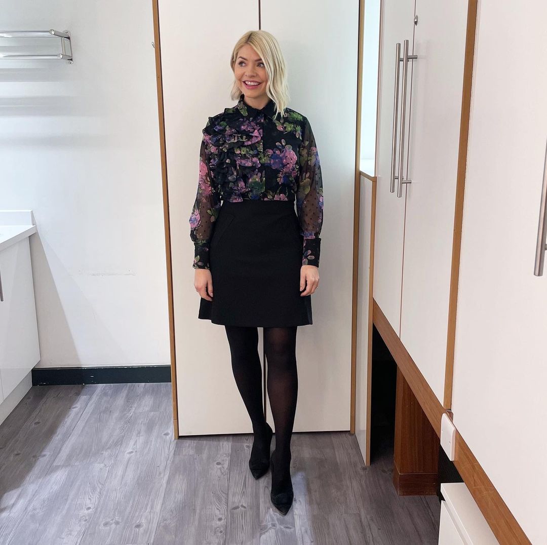 where to get all Holly Willoughby This Morning outfits black pink purple floral blouse black mini skirt black suede court shoes 6 February 2023 Photo Holly Willoughby