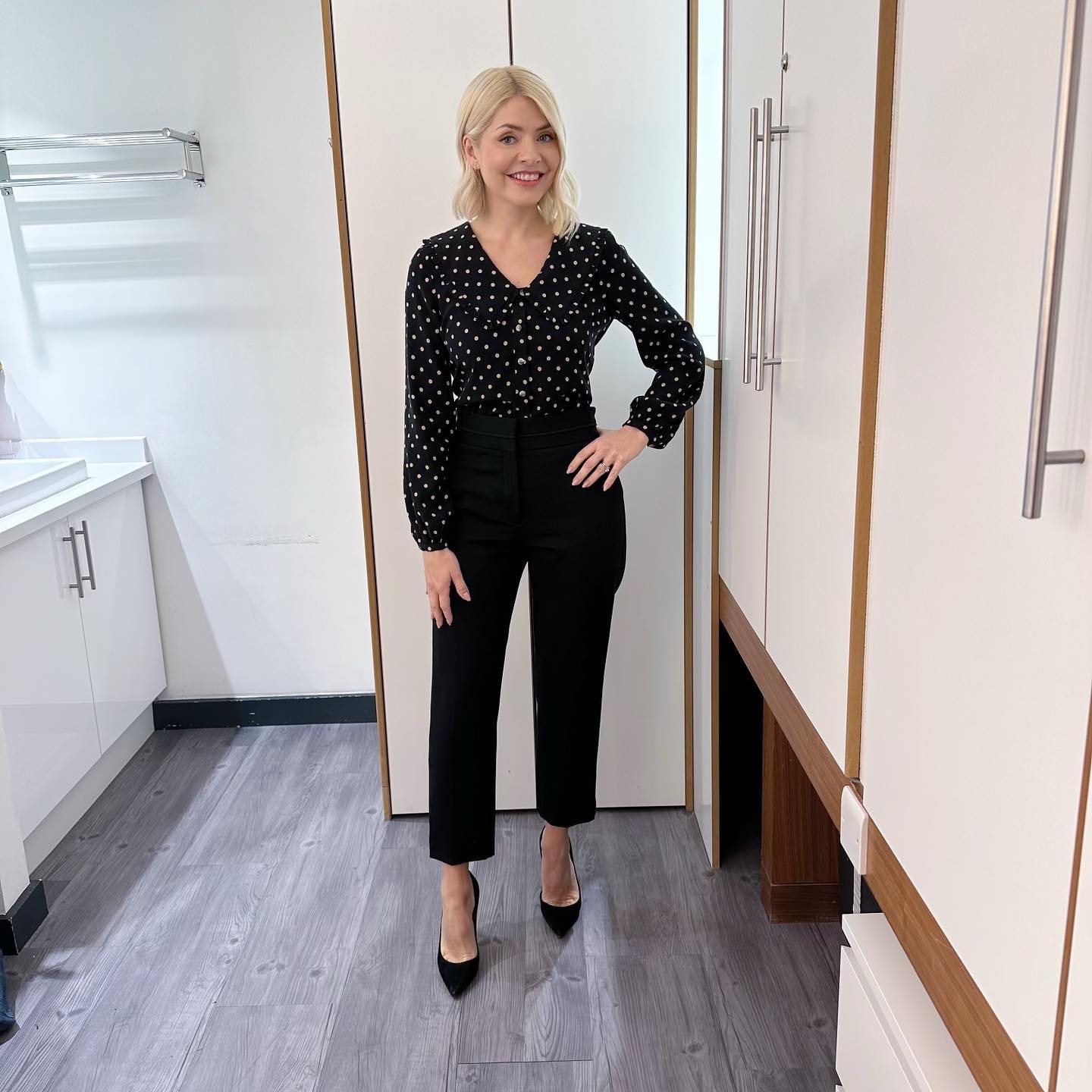 where to get all Holly Willoughby This Morning outfits black polka dot collar blouse shirt black slim trousers black suede court shoes 14 March 2023 Photo Holly Willoughby