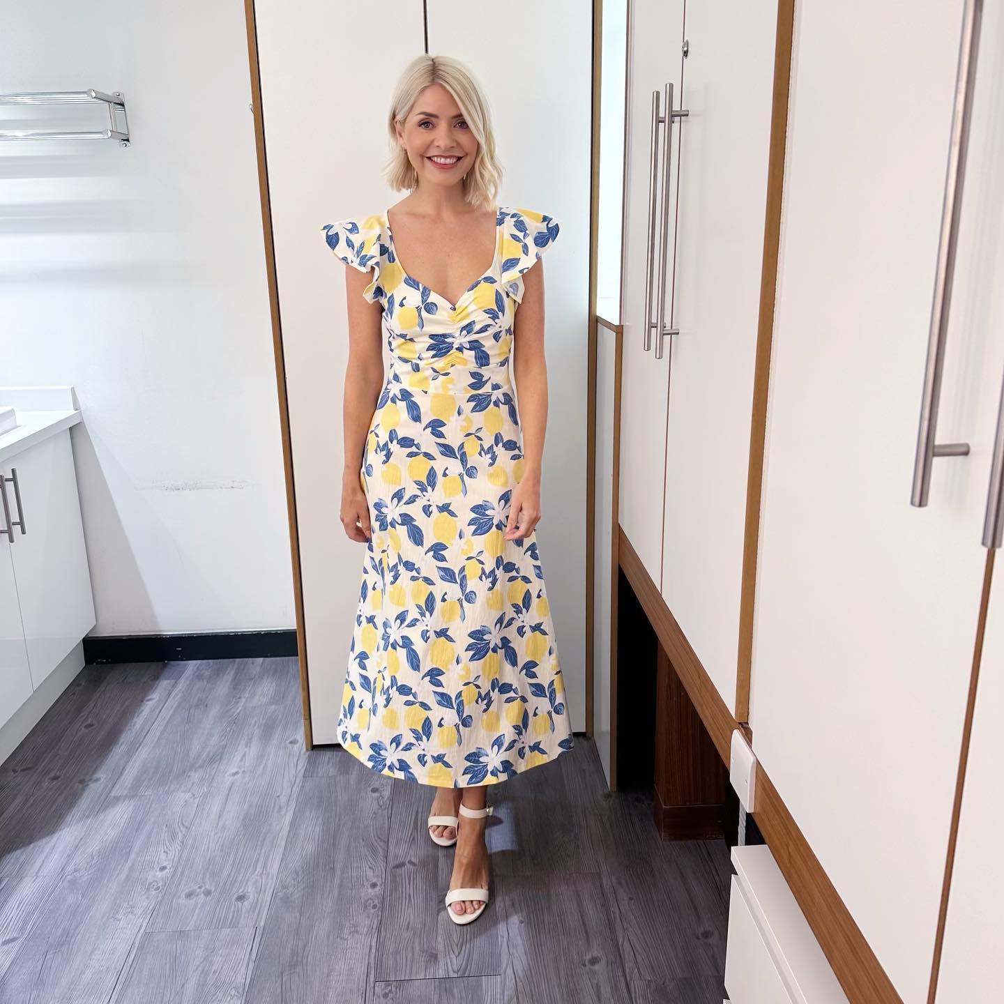 where to get all Holly Willoughby This Morning dresses white and blue lemon print ruffle shoulder maxi dress white sandals 4 July 2023 Photo Holly Willoughby