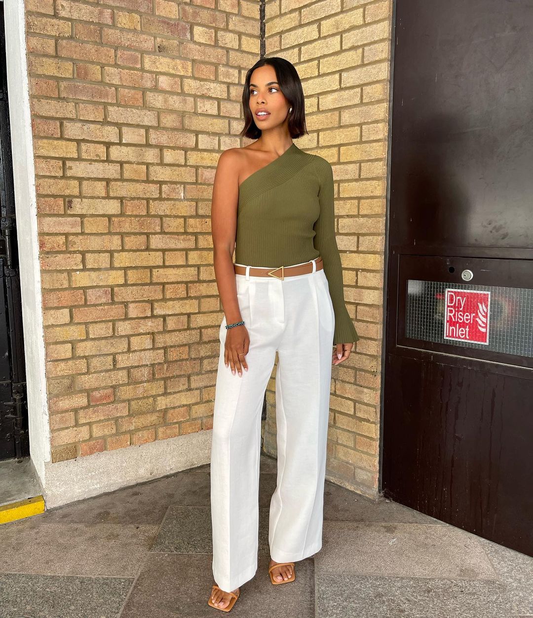 where to get all Rochelle humes This Morning outfits green rib knit one sleeve top white trousers neutral mules brown belt 15 August 2023 Photo Amber Jackson