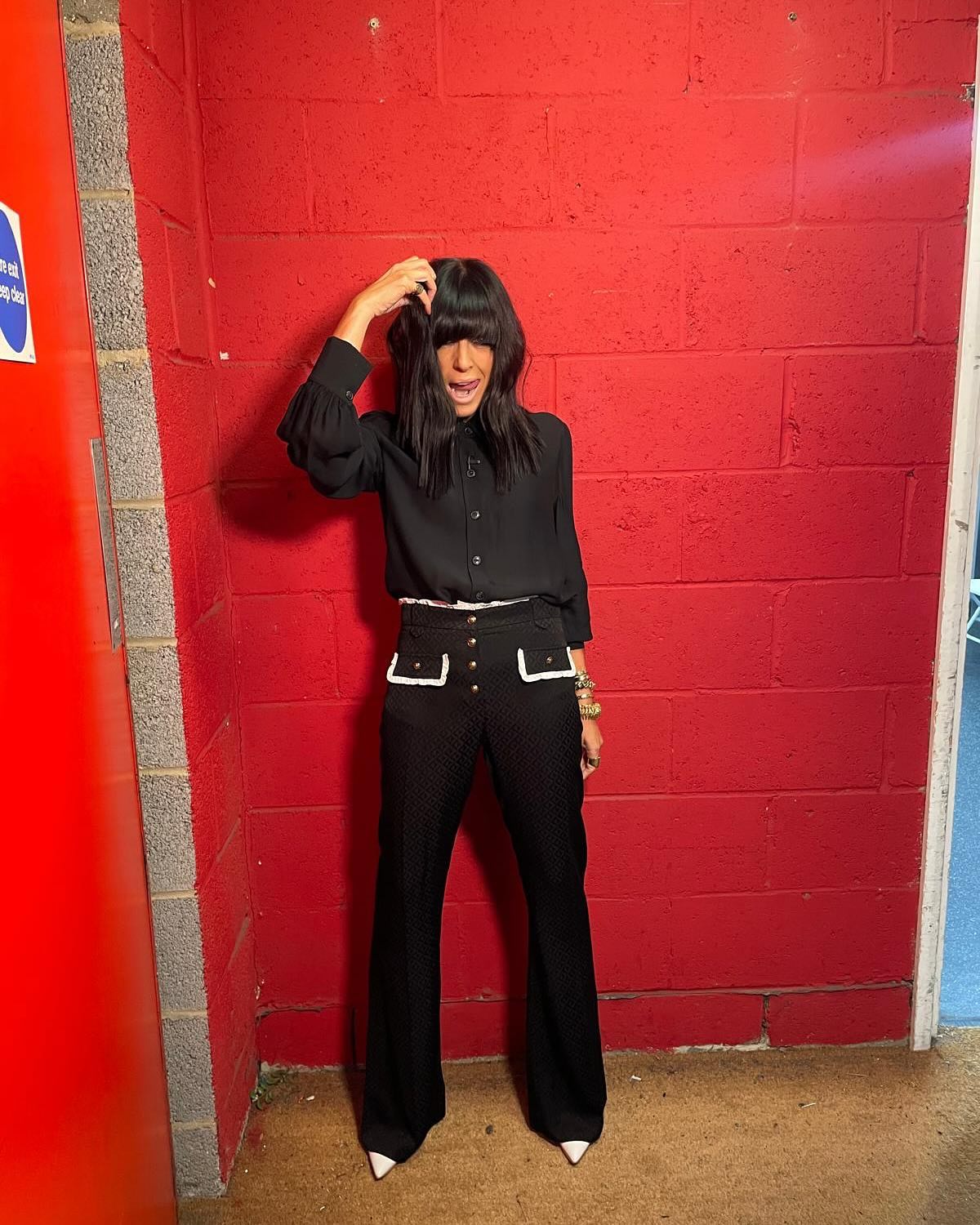 where to get all claudia Winkleman Strictly Come Dancing outfits black flare trousers white frill waistband and pockets black blouse shirt what is Claudia wearing 23 November 2024 Photo Sinead McKeefy