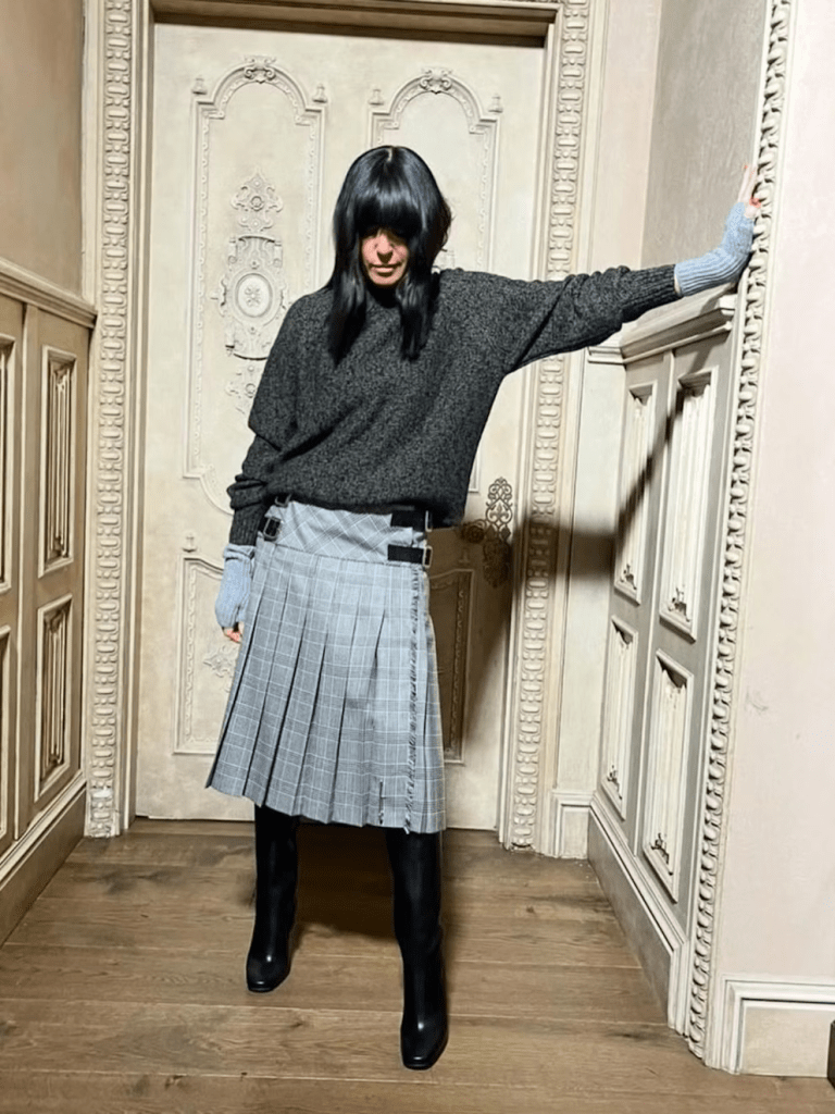 where to get all claudia Winkleman The Traitors outfits grey jumper grey kilt grey fingerless gloves black boots what is Claudia wearing  January 2025 Photo Claudia Winkleman