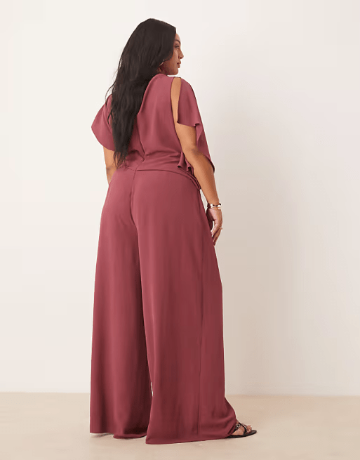 ASOS DESIGN Curve jumpsuit in washed burgundy with asymmetric draped neckline back view