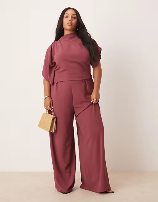 ASOS DESIGN Curve jumpsuit in washed burgundy with asymmetric draped neckline