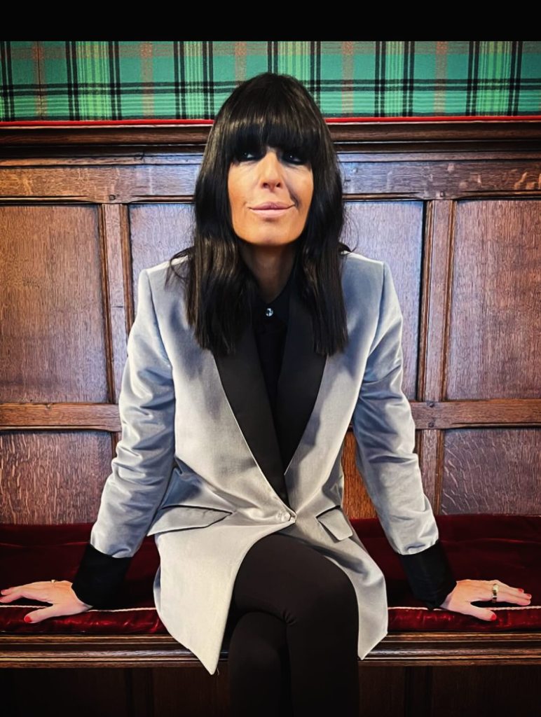 where to get all Claudia Winkleman Celebrity Traitors outfits dusky blue velvet blazer black tie and shirt 22 October 2025 Photo Sinead McKeefry