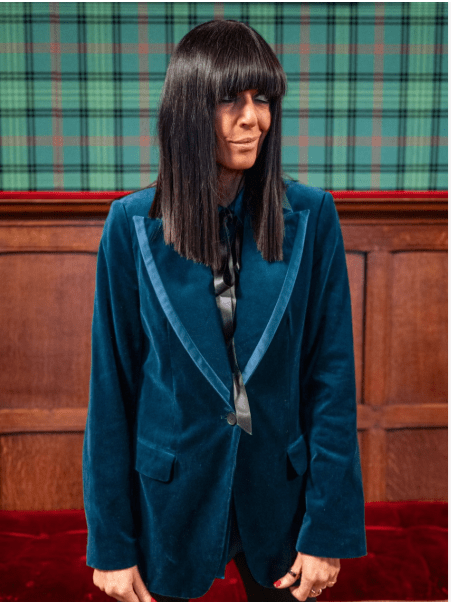 where to get all Claudia Winkleman Celebrity Traitors outfits petrol blue velvet satin trim blazer check shirt  30 October 2025 Photo BBC Studio Lambert