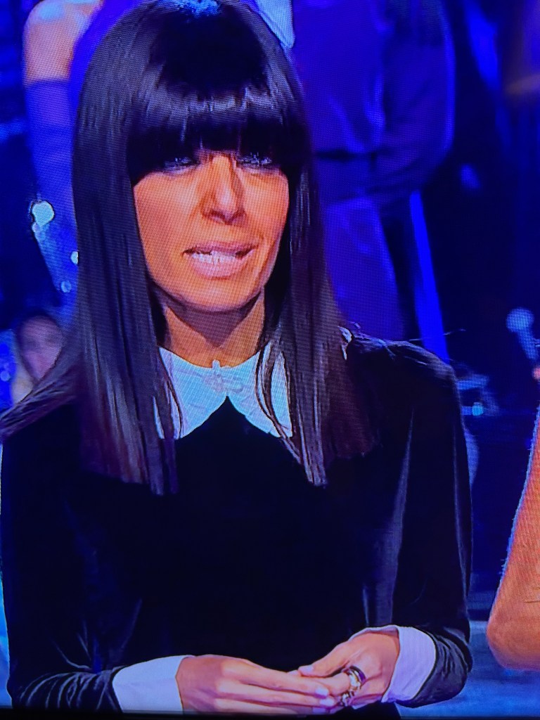 where to get all Claudia winkleman Strictly Come Dancing outfits b lack vevet mini drss with white colar and cuffs what is Claudia wearing 26 October 2025 photo BBC