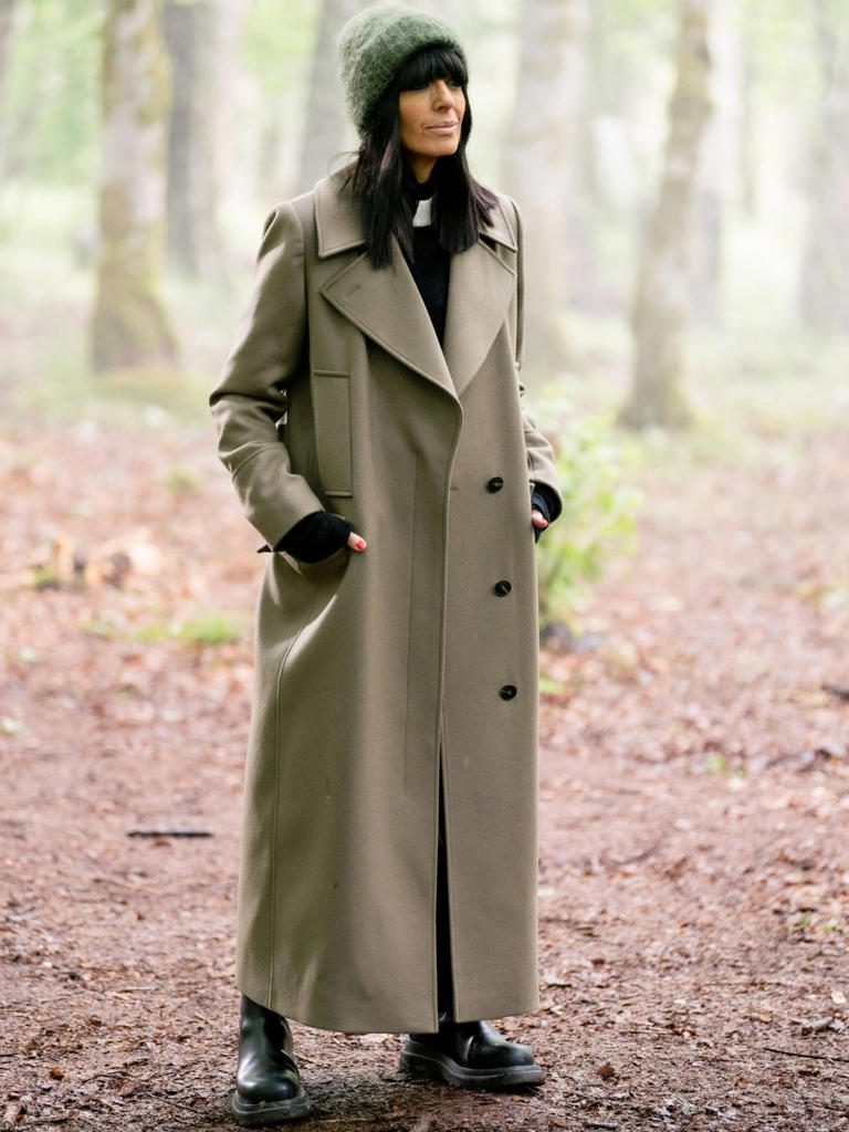 where to get all Claudia Winkleman The Traitors outfits black and white monochrome jumper pleated kilt black knee high boots khaki trench coat what is Claudia wearing 15 January 2026 Photo BBC Studio Lambert Cody Burridge