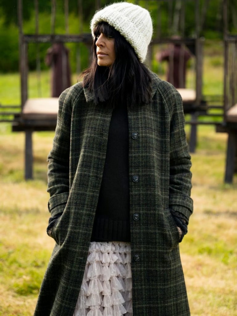 where to get all Claudia Winkleman The Traitors outfits  green check coat ruffle dress white knotted hat what is Claudia wearing 7 January 2026 Photo BBC Studio Lambert Euan Cherry