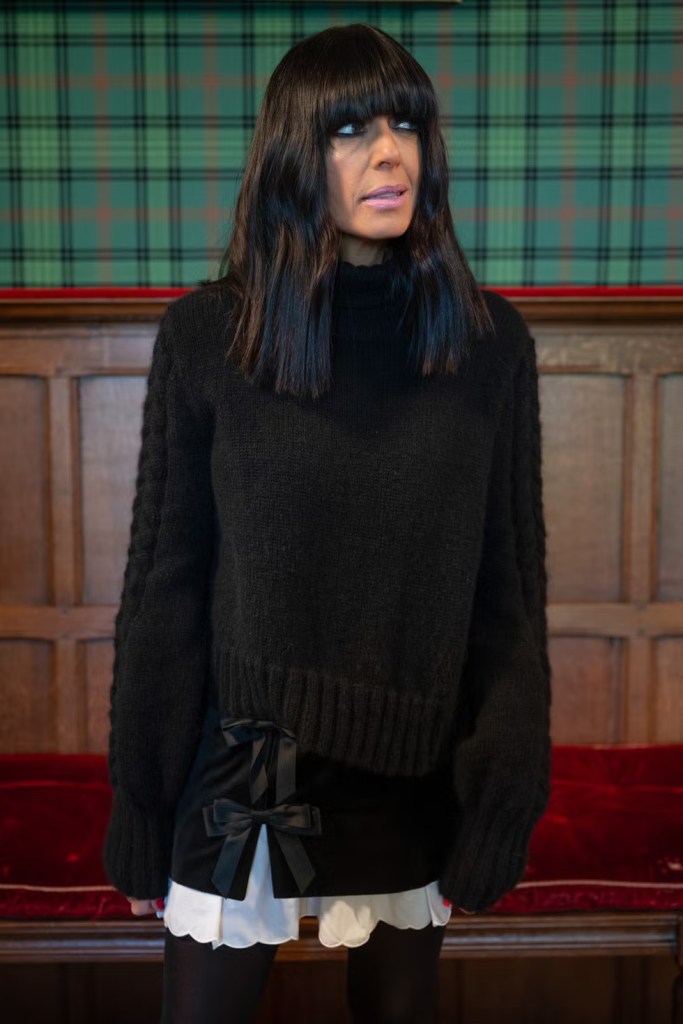 where to get all Claudia Winkleman The Traitors outfits  black cable sleeve jumper black mini skirt with bows what is Claudia wearing 21 January 2026 Photo BBC Studio Lambert v2